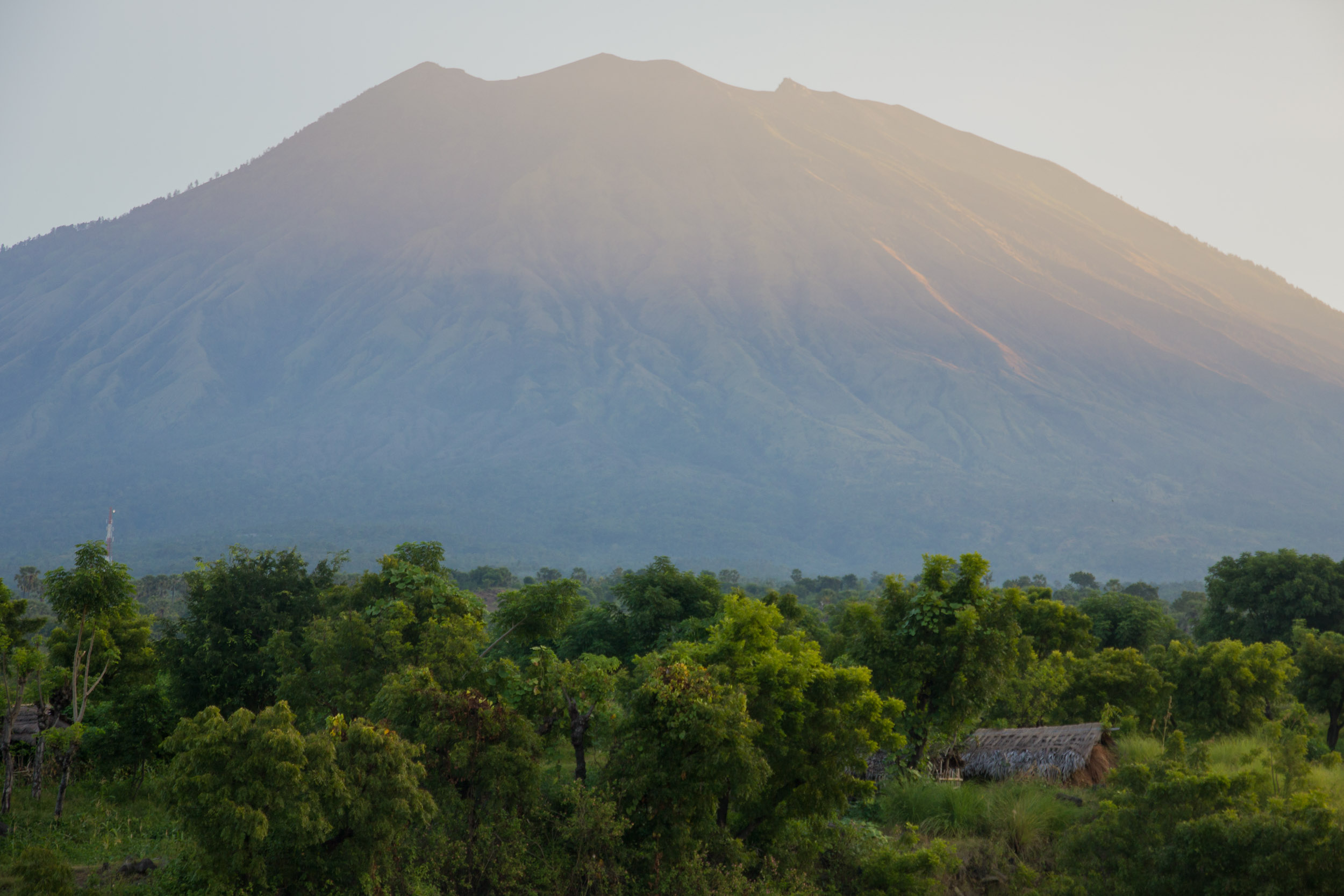 Mount Agung in Bali shrouded in a light haze and dominating the background