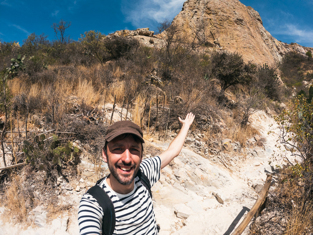 man (marek) taking a selfie on a dry, rocky hiking trail near Peña de Bernal, in Queretaro, Mexico