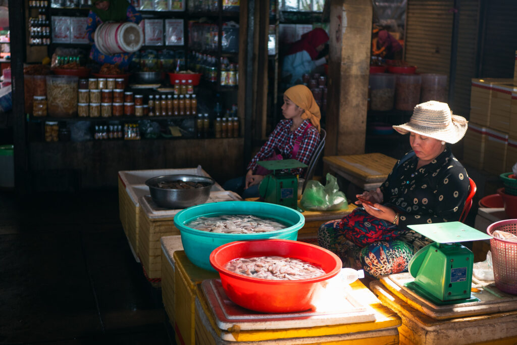Two women in an indoor market in Kampot