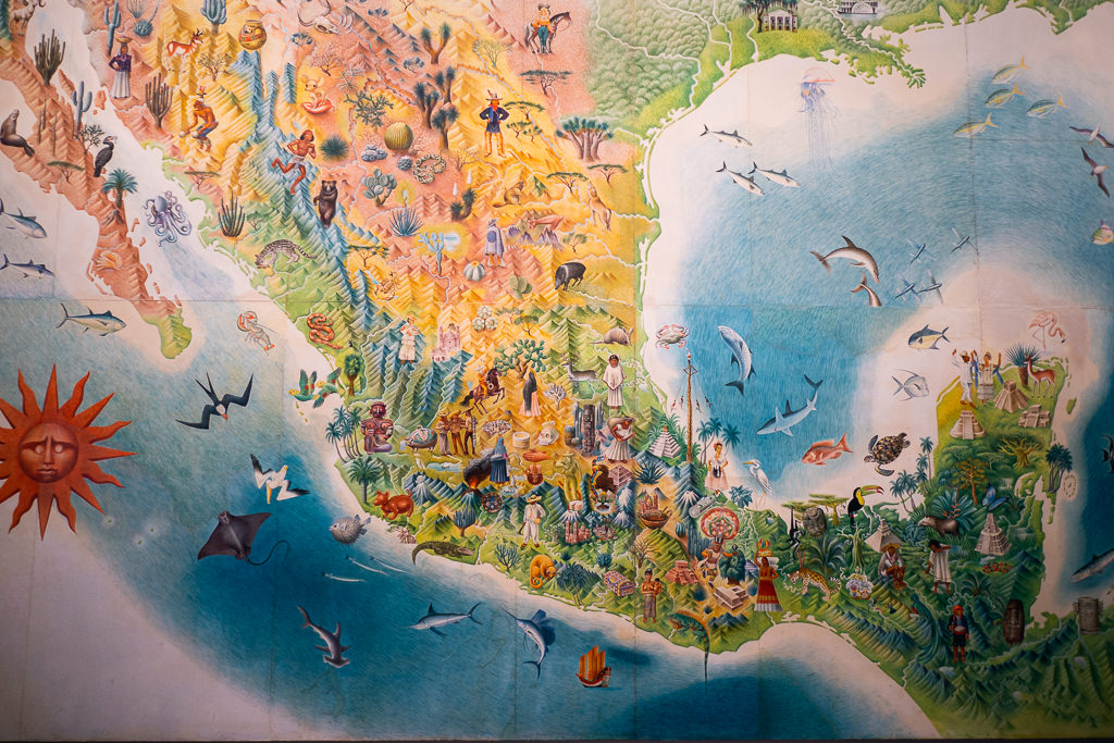Colorful illustrated map of Mexico showcasing regional wildlife, cultural elements, people in traditional clothing, local foods, landscapes, and marine life in surrounding waters