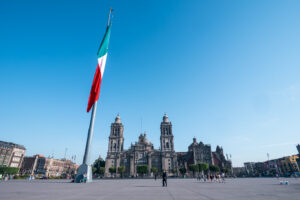 An image of Zocalo in Mexico City with the country's flag raised in the middle