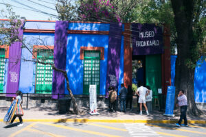 Visitors gathered outside the vividly colored entrance of the Frida Kahlo Museum in Mexico City