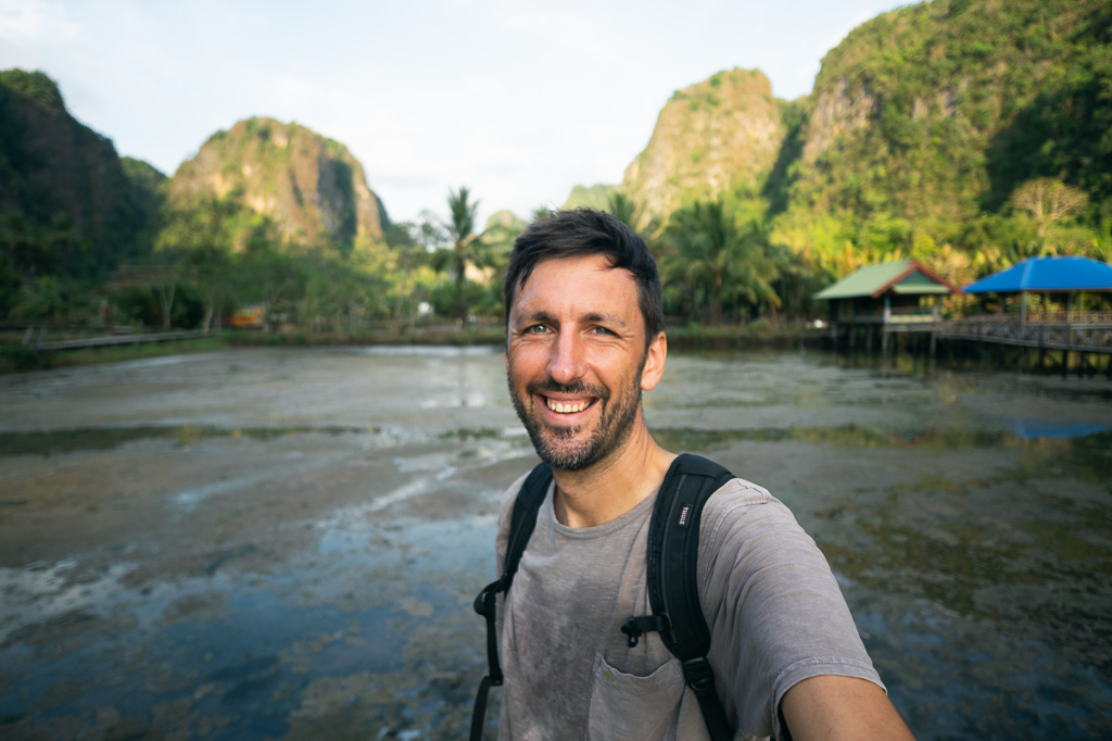Man (Marek) with a backpack taking a selfie in Rammang Rammang, Sulawesi