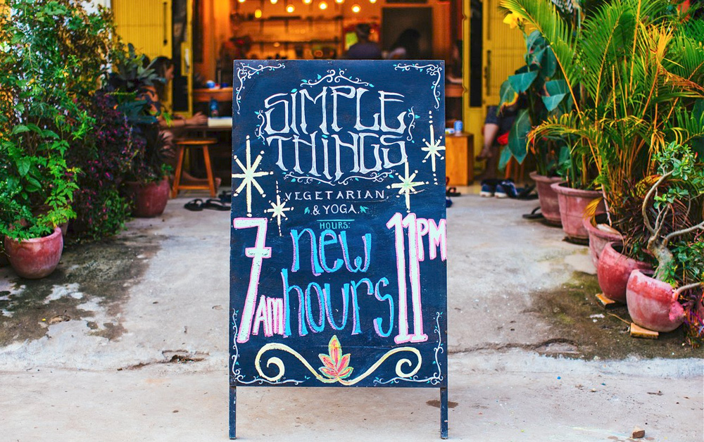 A chalkboard sign on the sidewalk of Simple Things restaurant
