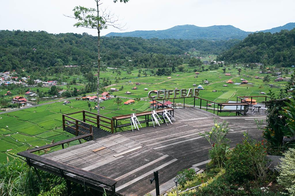 Panoramic view of bright green rice paddies from Cliffbar restaurant in Tomohon
