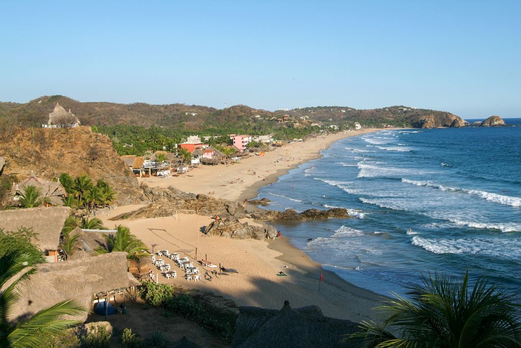 An expansive, elevated view of Zipolite Beach in Oaxaca, Mexico